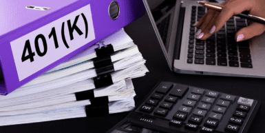 Fiduciary Responsibilities of a 401(k) Plan Administrator - hands type on a laptop by a pile of paperwork and a purple binder that reads 401(k)