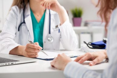 Doctor Consulting Patient about Health Care Provider and Plan Options