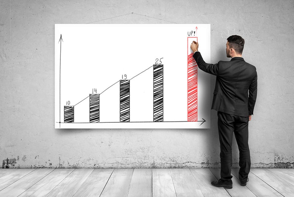 business man writing upward chart with red growth