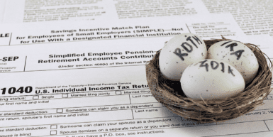 SECURE Act 2.0 Makes Changes to RMD Age, Contribution Limits and More - a nest with three eggs sits on a 1040 form