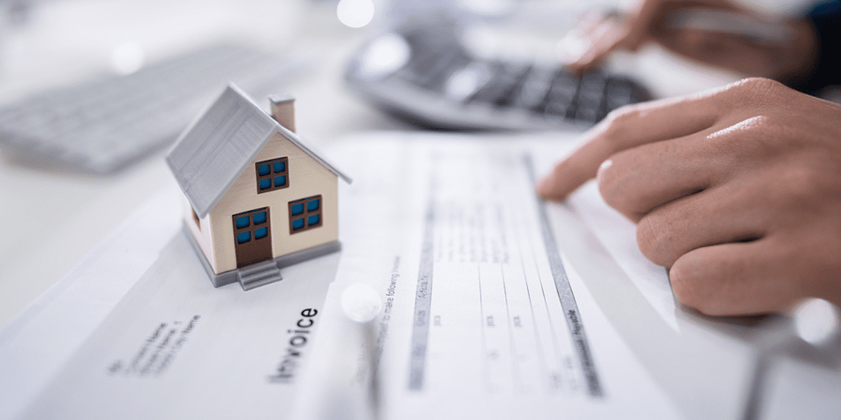Real Estate Professional Tax Status: Do You Qualify? - a person checks an invoice for their real estate property